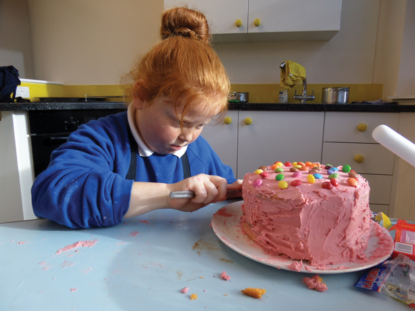 Year 4 student Kiera Price puts the icing  on her cake 