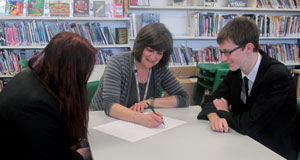 Carol Dallas works with Broadland students at an after-school session