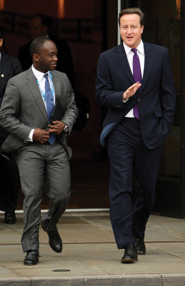 Prime Minister David Cameron (right) leaves the party hotel with MP for East Surrey Sam Gyimah, on the final day of the Conservative Party Conference at Manchester Central Convention Centre. (2011) /PAGyimah