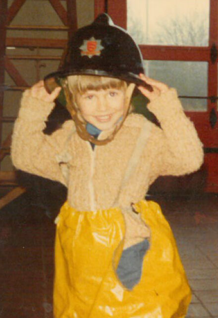 Simon in a fireman’s hat age 5 at Halsted fire station in Essex