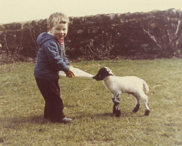 Neil feeding a lamb at the family farm near Elston