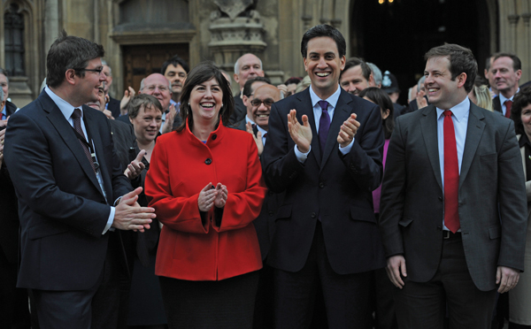 Former Labour leader Ed Miliband welcomes newly elected MPs to the House of Commons in London after 2012 by-elections, including Lucy Powell (second left)