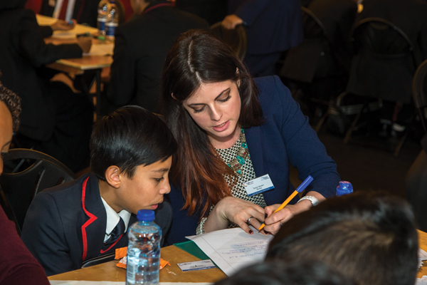 Barclay’s volunteer, Tarryn Severn, helps a Landgon Park School pupil with the Stationary Rocks plan