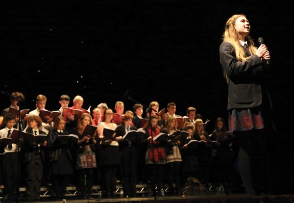 Olivia Hewitt-Jones performing a solo accompanied by Caterham School Chamber Choir