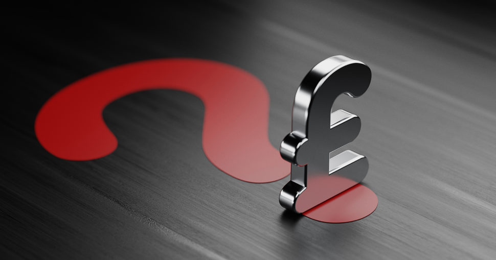British Pound Symbol And A Red Question Mark On Black Wood Surface | Schools Week