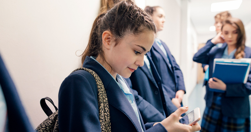 Student-with-mobile-phone-feat | Schools Week mobile phone ban