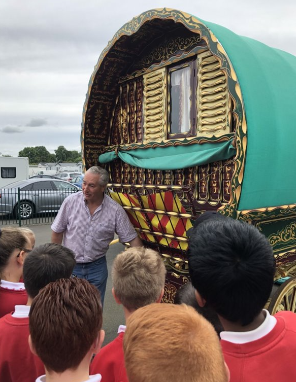 Gypsy leader Billy Welch shows St Teresa's pupils traditional and new caravans.