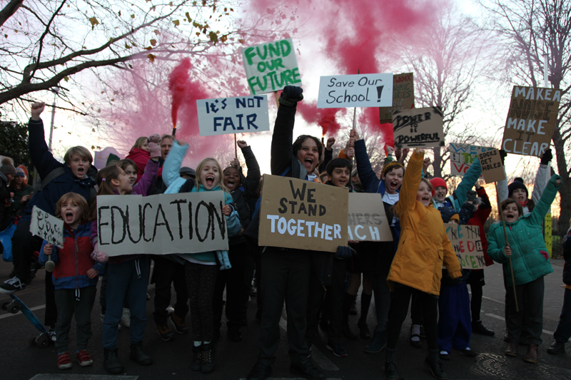 Pupils with placards seen in the music video to the school's Christmas single