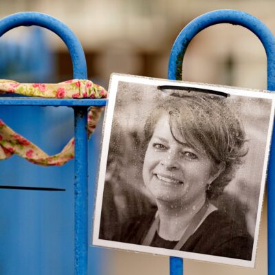 A photograph of Ruth Perry attached to the fence outside John Rankin School